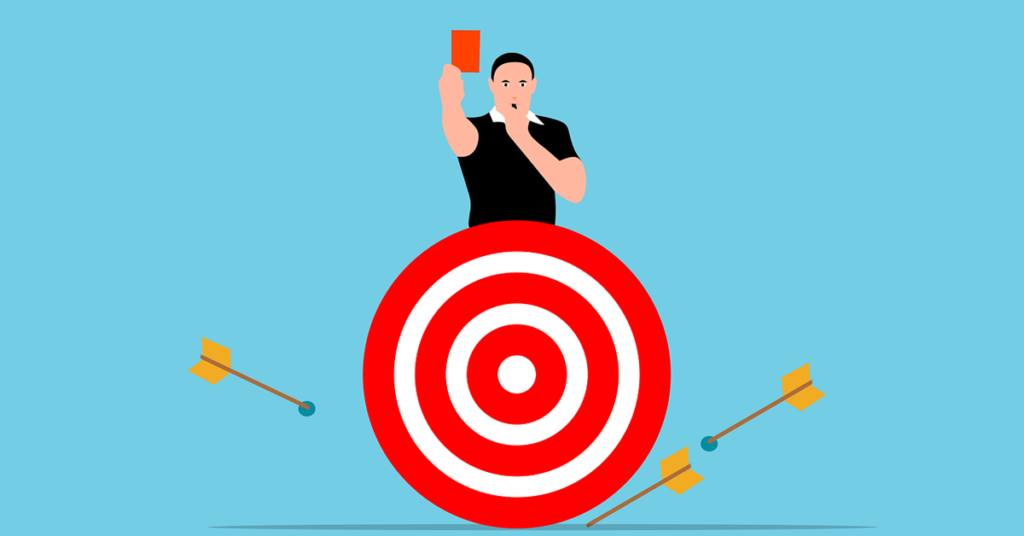 A referee holds a red card. In front of him is a missed target, illustrating the concept of failure and the ways we learn from failing.